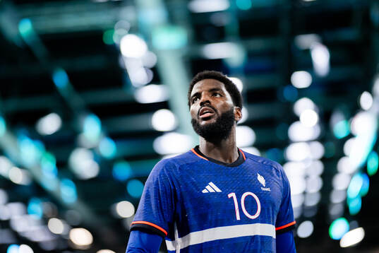 Dika Mem of France celebrates in a men's preliminary round