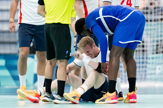 Magnus Gullerud of Norway in pain in a men's preliminary