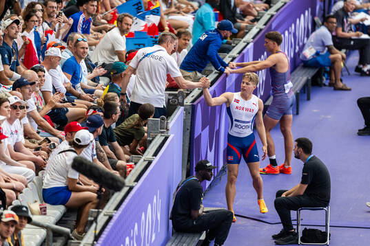 Markus Rooth of Norway talks to his coach when competing in
