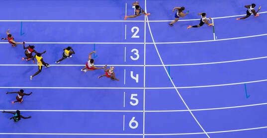 Athletes pass batons when competing in athletics 4x400