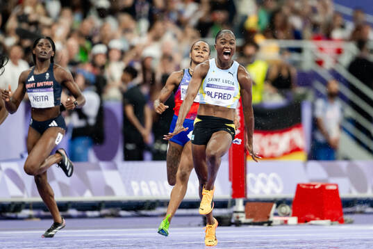 Julien Alfred of Saint Lucia celebrates
