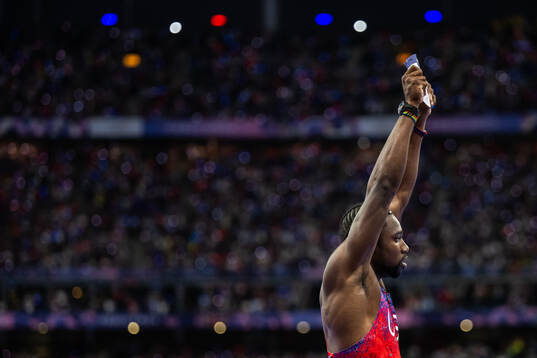 Noah Lyles of USA celebrates