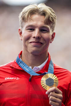 Markus Rooth of Norway celebrates with his gold medal at