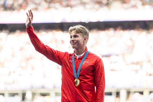 Markus Rooth of Norway celebrates with his gold medal at