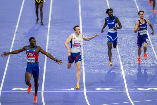 Karsten Warholm of Norway looks dejected while Rai Benjamin