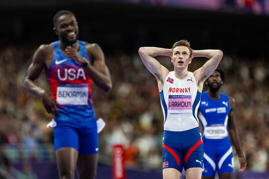 Karsten Warholm of Norway looks dejected while Rai Benjamin