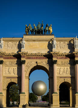 The Olympic Cauldron seen through Arc de Triomphe du