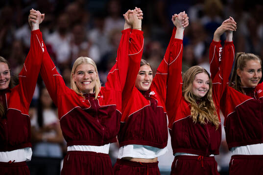 Players of Denmark celebrate their bronze at the medal
