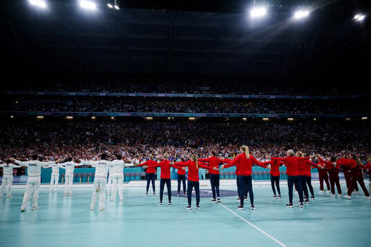 Players of France and of Norway celebrate their silver and