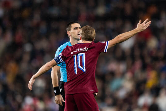 Referee Vladan Todorovic and Martin Ødegaard of Norway