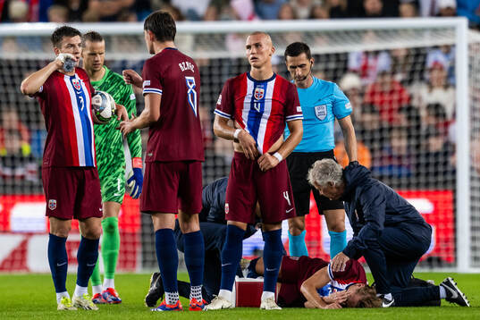 Martin Ødegaard of Norway receives medical attention