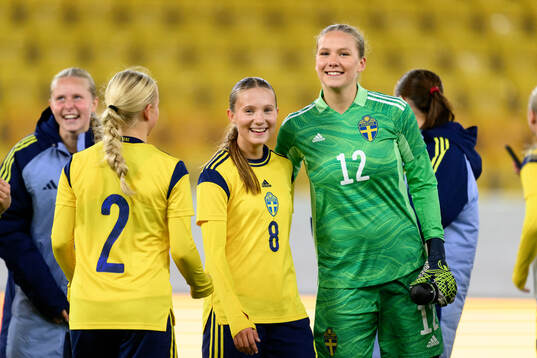 Fanny Peterson and goalkeeper Hanna Karlsson of Sweden