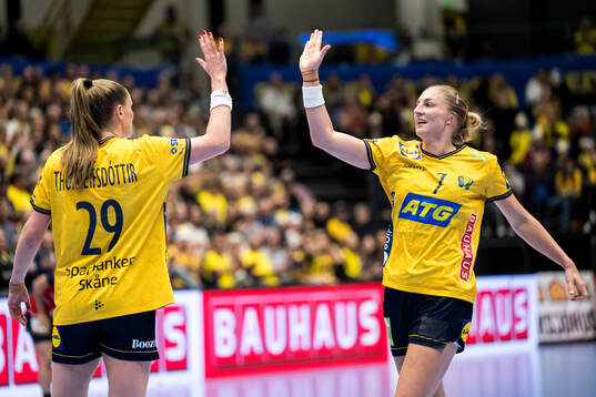 Kristin Thorleifsdottir and Linn Blohm of Sweden celebrate