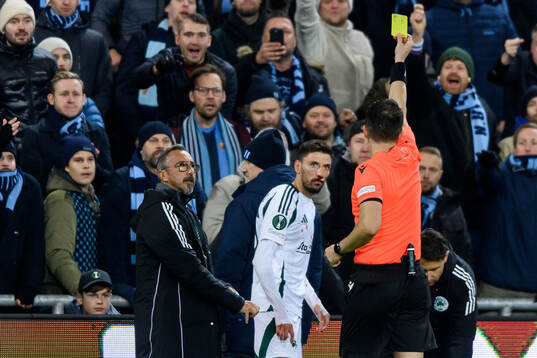Filip Mladenovic of Panathinaikos receives a yellow card
