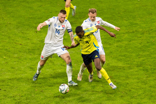 Milan Skriniar of Slovakia and Alexander Isak of Sweden