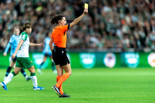 Referee Silvia Gasperotti shows a yellow card
