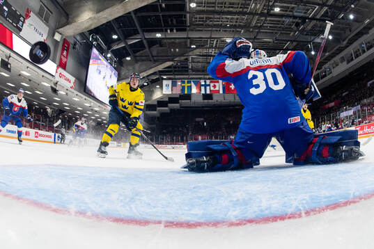 Isac Hedqvist of Sweden and goaltender Samuel Urban of