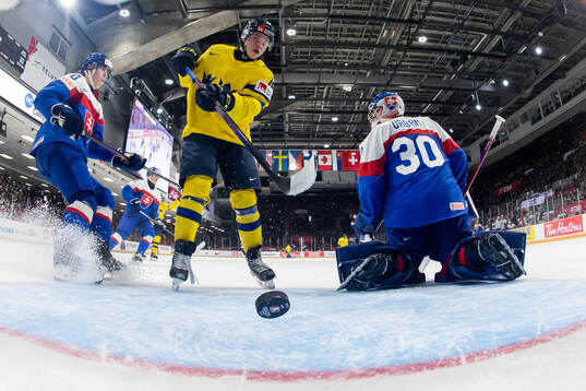 Isac Hedqvist of Sweden and goaltender Samuel Urban of