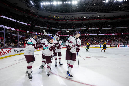 Eriks Mateiko of Latvia celebrates with team mates