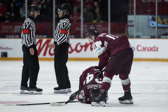 Daniels Serkins of Latvia in pain and is taken care of by