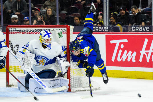 Goaltender Petteri Rimpinen of Finland and Linus Eriksson