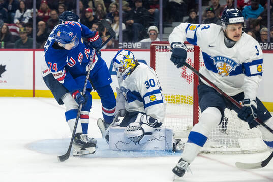 Brodie Ziemer of USA and goaltender Petteri Rimpinen of