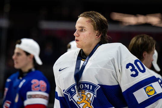 goaltender Petteri Rimpinen of Finland looks dejected