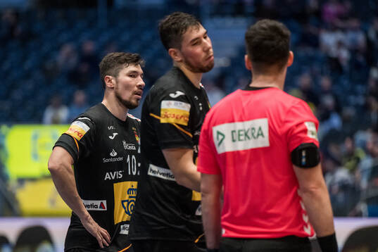 Alex Dujshebaev and Daniel Dujshebaev of Spain react