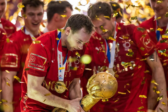 Mathias Gidsel of Denmark celebrates with the trophy