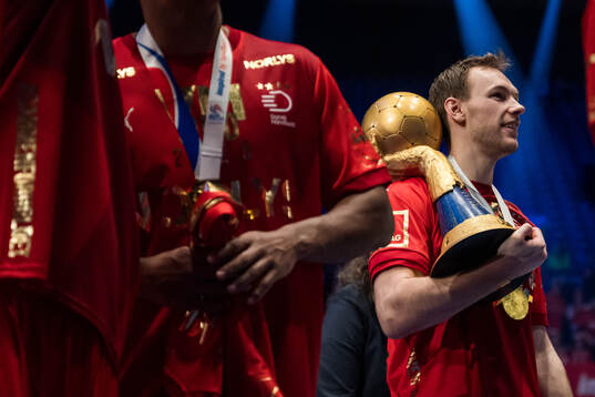 Mathias Gidsel of Denmark celebrates with the trophy