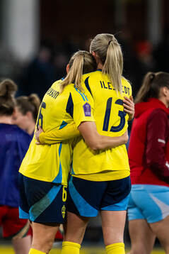 Magdalena Eriksson and Amanda Ilestedt of Sweden embrace
