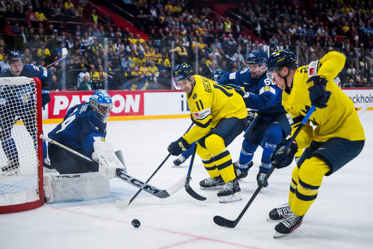 Goaltender Juuse Saros of Finland and Mikael Backlund of