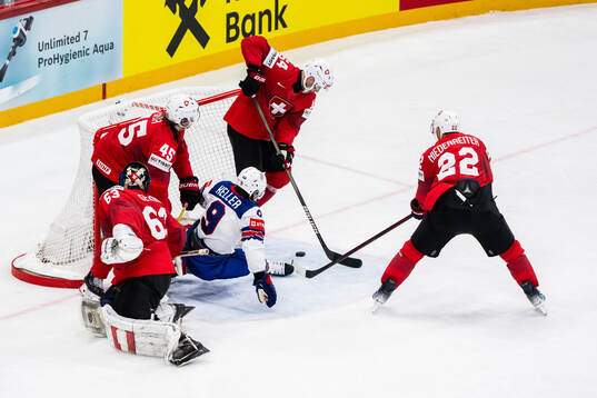 Michael Fora, goaltender Leonardo Genoni and Christian