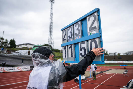 A volunteer with a result board