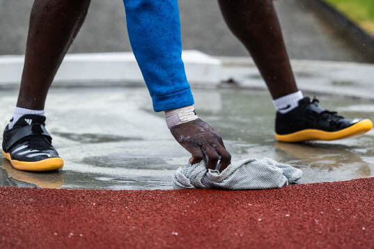 An athlete dries the ring with a towel