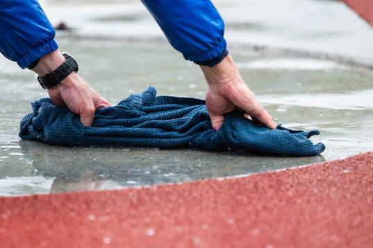 An athlete dries the ring with a towel