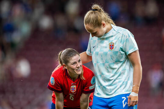 Maren Mjelde and goalkeeper Aurora Mikalsen of Norway look