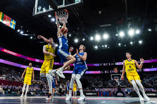 Miikka Muurinen of Finland dunks the ball infront of Simon