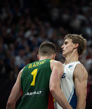Marek Blazevic of Lithuania and Lauri Markkanen of Finland