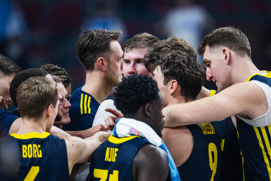Simon Birgander of Sweden gather the players