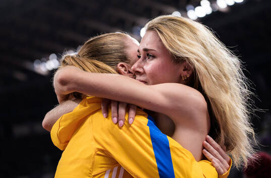 Ellen Ekholm of Sweden comforts a crying Engla Nilsson of