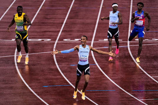 Busang Collen Kebinatshipi of Botswana celebrates winning