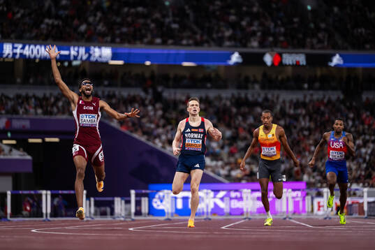 Abderrahman Samba of Qatar celebrates next to Karsten
