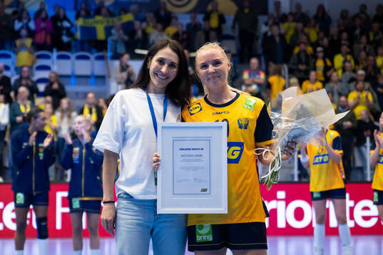 Mathilda Lundström of Sweden receives the players of the