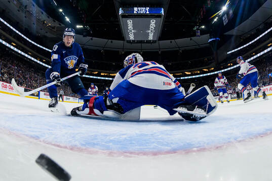 Leo Tuuva of Finland scores the 2-2 goal behind goaltender