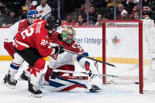 Porter Martone of Canada and goaltender Michal Orsulak of