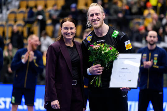 Goalkeeper Mikael Apelgren of Sweden is awarded player of
