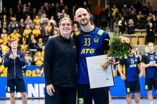 Lukas Sandell of Sweden receives an award for player of the