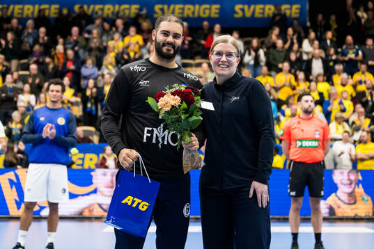 Goalkeeper Rangel da Rosa of Brazil receives an award for