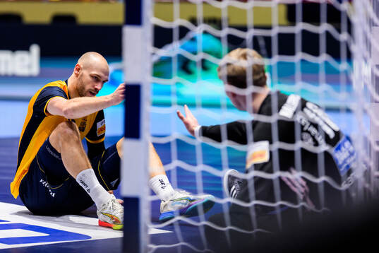 Lukas Sandell of Sweden and goalkeeper Viktor Hallgrimsson